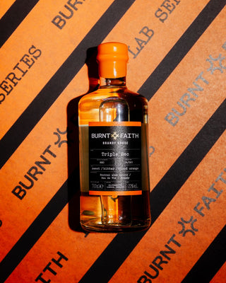Burnt Faith Triple Sec Orange background portrait