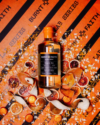 Burnt Faith Triple Sec orange background with fruit