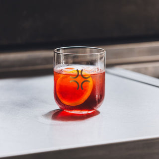 Aged Negroni in branded glass