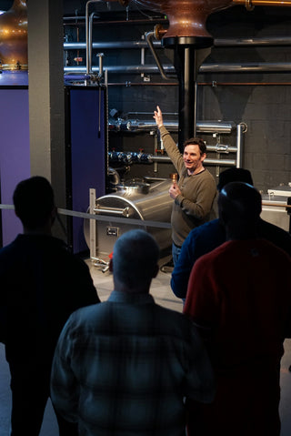 Man stood in front of a Brandy still